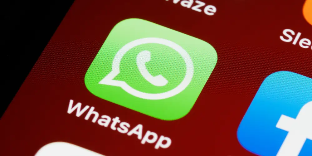 WhatsApp app icon and a glimpse at the Waze app and the Facebook app