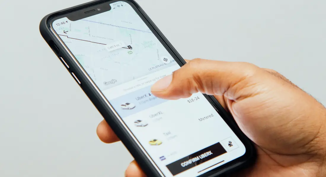 iPhone showcasing the Uber app's "confirm UberX" prompt when booking an Uber ride.